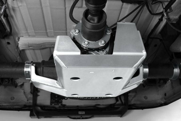 Underside of a vehicle showing a metal differential guard protecting the drivetrain