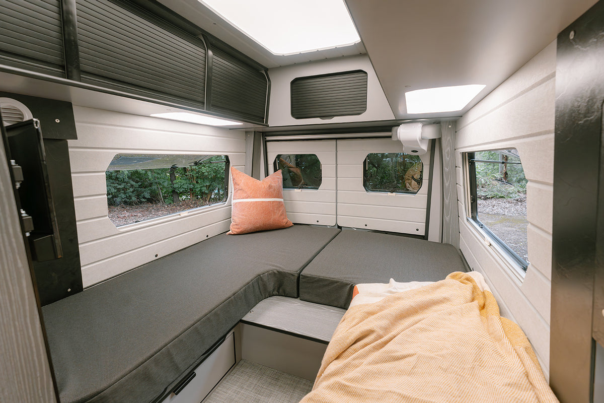 Jabiru interior with rear lounge seating, cushions and side windows