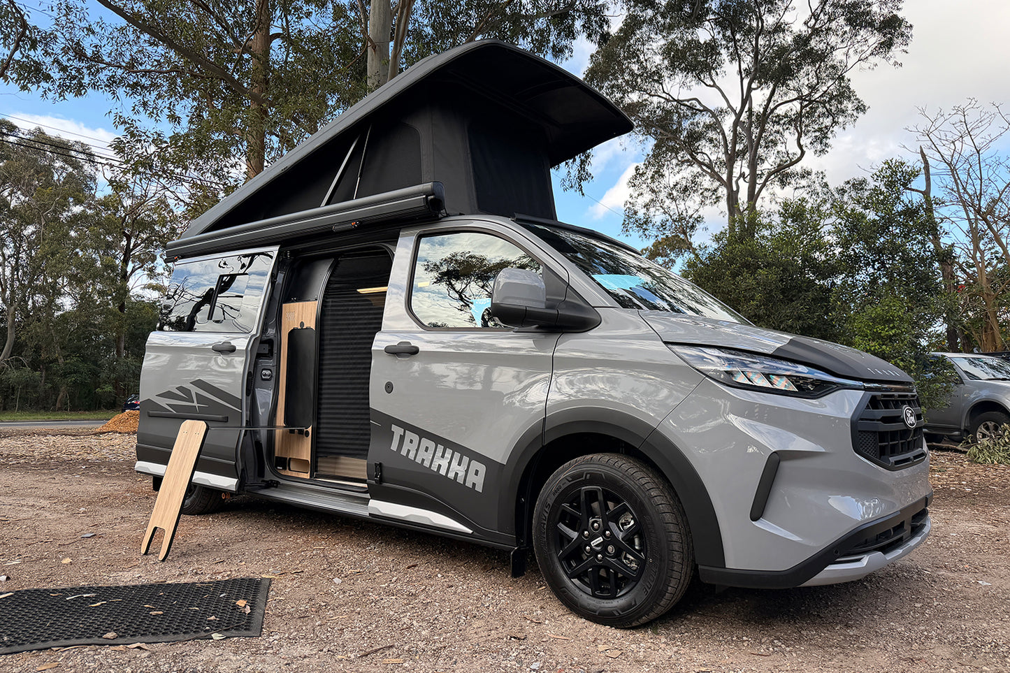 Grey Trakkadu on Ford Transit Custom with pop top raised and sliding door open