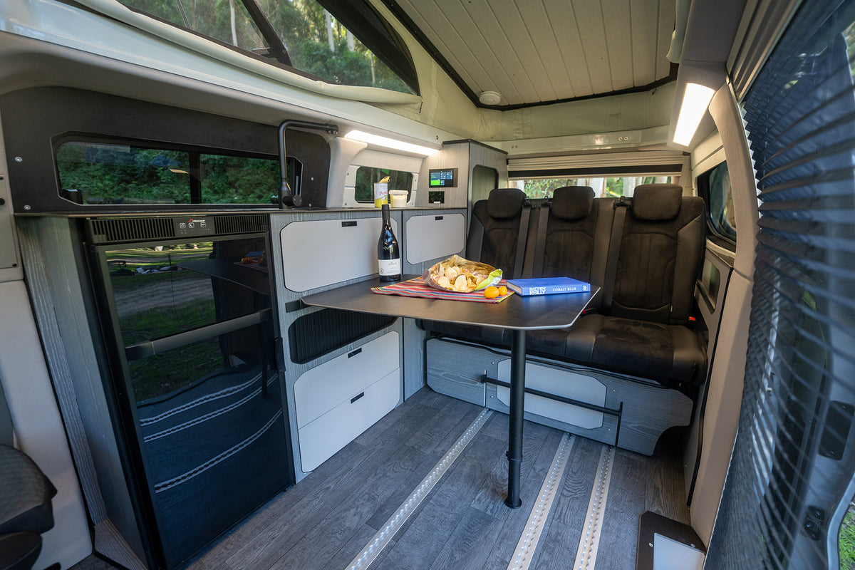 Trakkadu interior with dining table and rear bench seat (model photo)