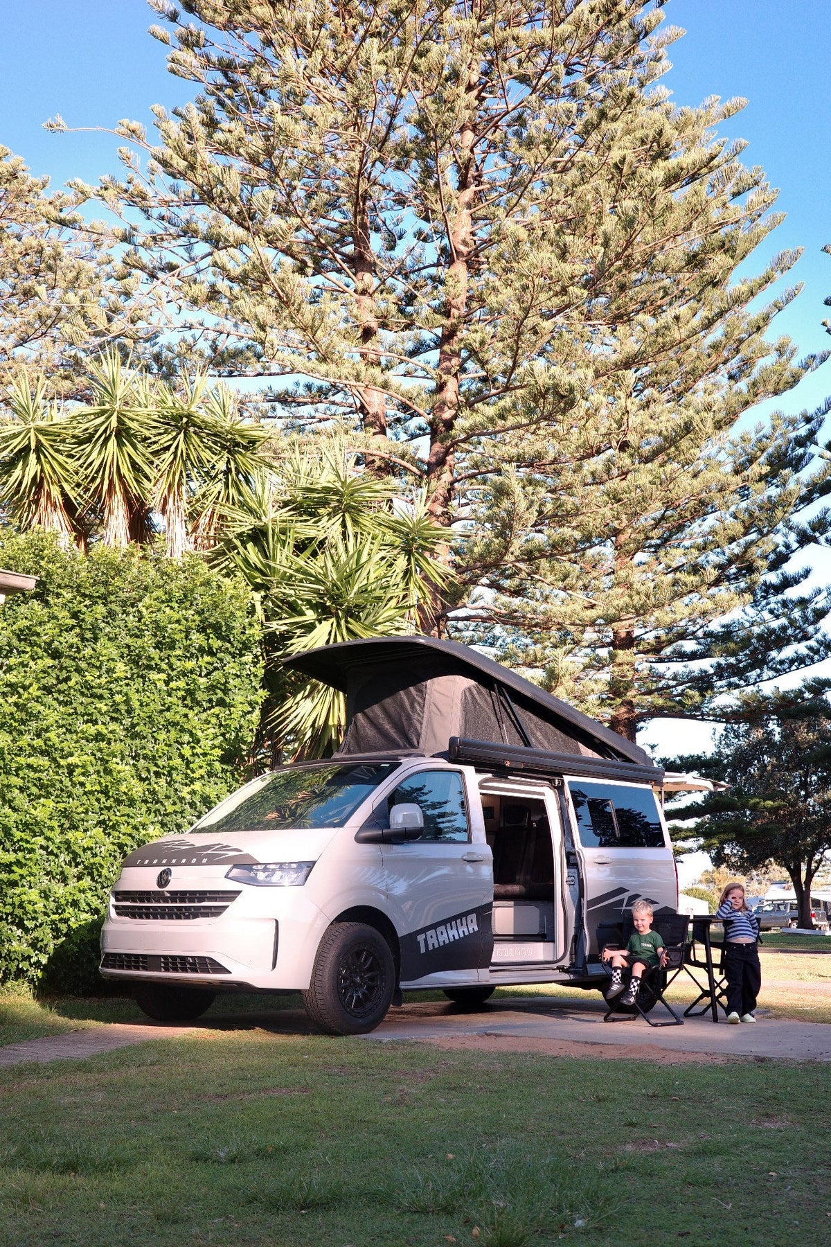 Trakkadu pop top campervan set up at a coastal caravan park